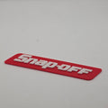 Snap-off novelty toolbox badge